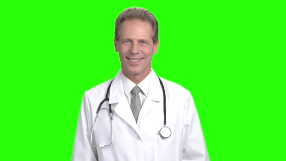 Middle Aged Smiling Male Doctor. alt