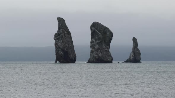 Zoom in view of rocky islands in Pacific Ocean, Kamchatka Peninsula seascape