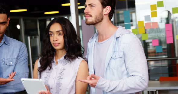 Executives using digital tablet alt