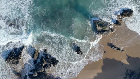Aerial View of Waves Hitting Rocks Shot From Directly Above