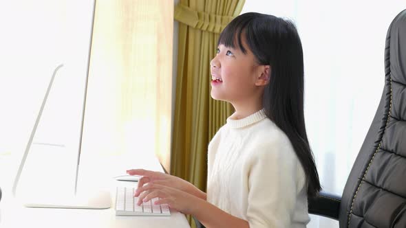 Close Up Of Cute Asian Girl Using Pc alt