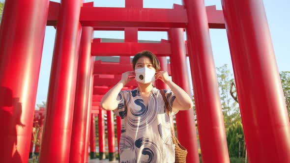 young attractive asian female wearing face mask virus protective at japan tradition temple
