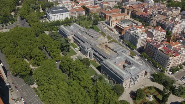 Drone is Flying Over the Trees Around a Big Building in Valencia Spain alt