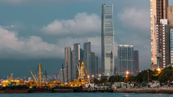 Hong Kong Business Center Day to Night Timelapse with a Cloudy Blue Sky After Sunset alt