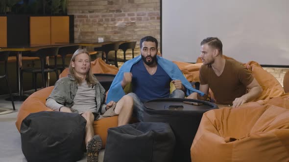 Wide Shot of Multiethnic Men with Ukraininan Flag Rejoicing Victory of Favourite Team. Caucasian and alt