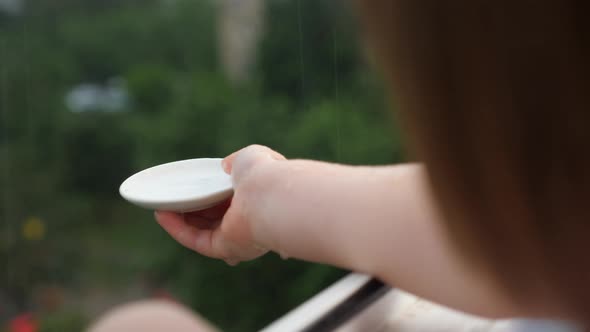 LIttle Hand Play Catching Rain Drops on Blurred Background. Pure Fresh Ecology. Little Girl Play