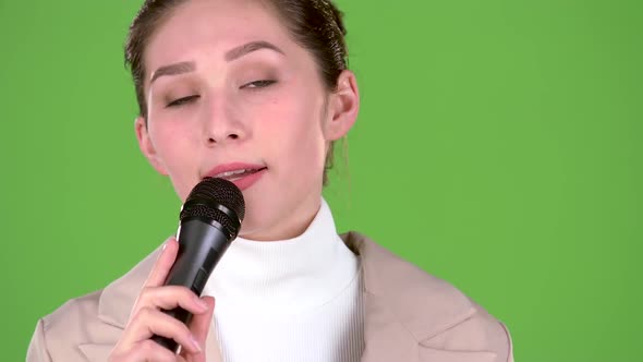 Singer Sings a Cheerful and Melodic Song. Green Screen alt