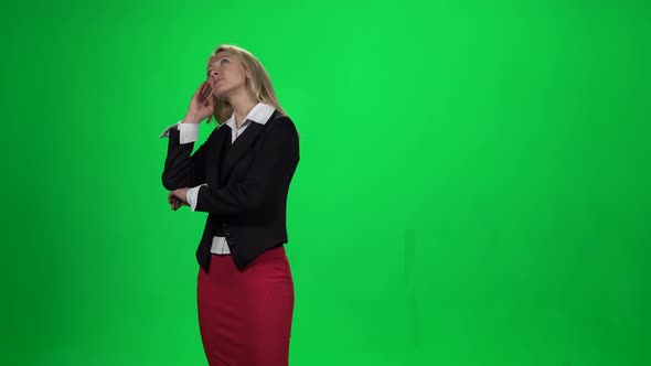 Blond Female Looking Upset Standing Against Green Screen Chroma Key Background alt