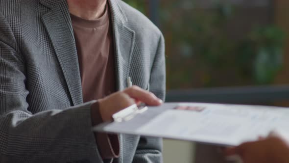 Senior Businessman Giving CV to HR Manager on Job Interview alt