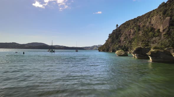 Flying past floating boats moored in Ferry landing, New Zealand alt