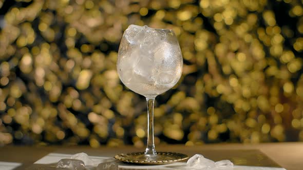 Cocktail is Poured to the Glass Full of Ice Ice Cubes and Sprinkling Soda  120Fps Prores HQ alt