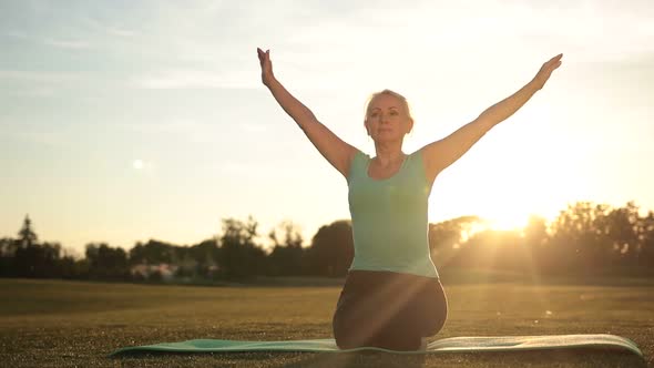 Fitness Woman Exercising Yoga Poses at Sunset alt