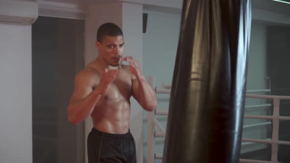 Self Improvement Athletic Fighter Trains His Punches Kicks a Punching Bag Training Day in the Boxing alt