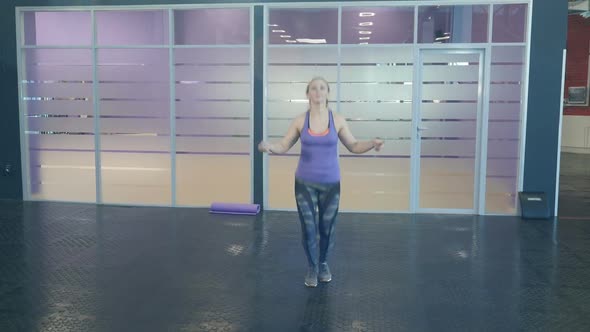 Energetic Fitness Girl Jumping a Skipping Rope in Fitness Wellness Studio Gym.