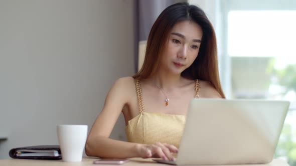 Young beautiful woman working with laptop at coffee shop