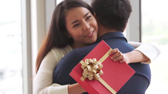 Romantic Couple Giving Gift to Lover at Restaurant alt