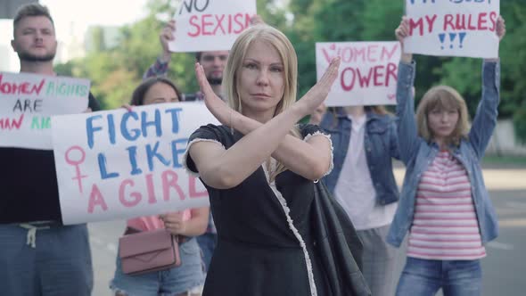 Confident Caucasian Woman Crossing Hands in No Gesture on Demonstration Against Sexism and Women alt