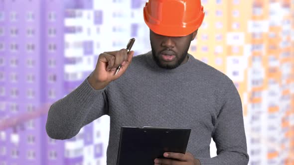 Afro-American Supervisor Writing on Clipboard alt