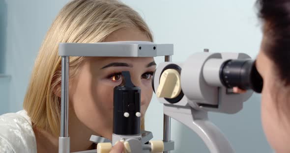 Young Woman Having Her Eyes Examined With Modern Medical Equipment Vitiligo alt