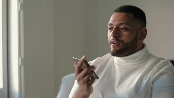 Confident Latin Guy Speaking on Cell Via Loudspeaker alt