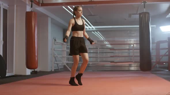 Woman Fighter Trains and Jumping Rope, Coordination Training, Kickboxing Training Day in the Boxing alt