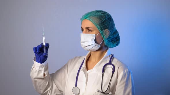 Doctor Holding a Syringe with Coronavirus Vaccine alt
