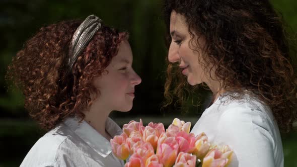 Portrait of a Mother and Daughter of a Teenager Looking at Each Other with Love and Tenderness