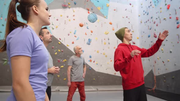 Instructor Giving Instruction in Climbing Center alt