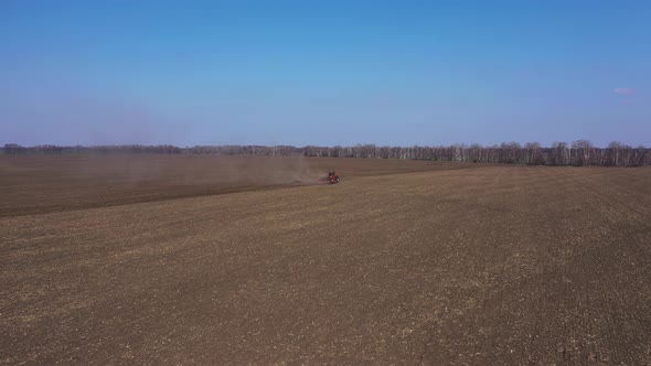 Red Tractor On The Field Working Aerial View alt