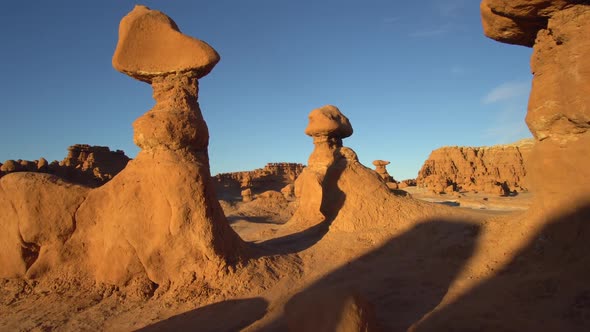 Moving through hoodoos in Goblin Valley during sunset alt