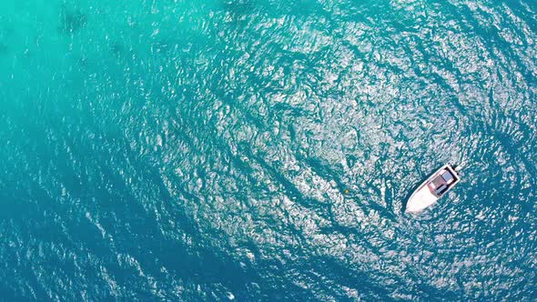 Aerial Top View of a Fishing Boat Sailing in Turquoise Waters of Ocean Zanzibar alt