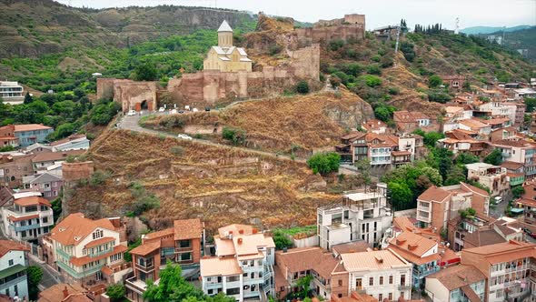 Aerial drone view of Tbilisi, Georgia at cloudy weather. St. Nicholas Church located on a cliff, bui alt