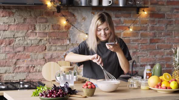 Skilled Culinary Blogger Holds Smartphone and Makes Video