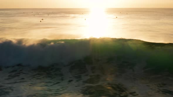 Following large waves at sunset