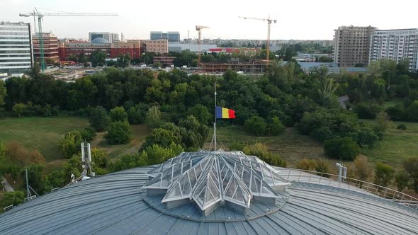 Aerial shot of Romanian flag waving on a building 3 alt