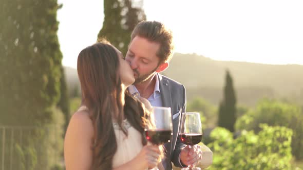 Good Looking Couple With Red Wine Outside