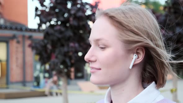 Young Woman with Short Fair Hair and Wireless Headphones alt