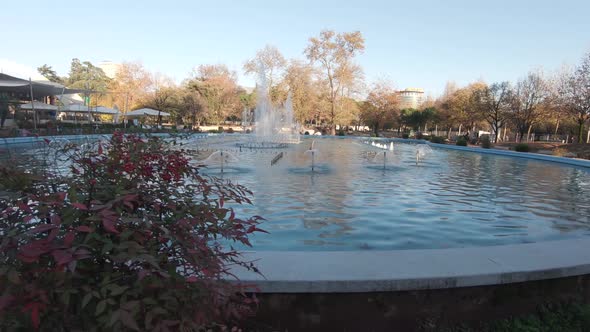 Beautiful fountain on a sunny day. Outdoors lifestyle concept. Sideways dolly alt