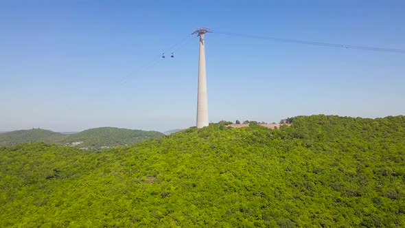 Aerial Fly Over Green Forest Mountain with Aerial Ropeway Transit ART in Island alt