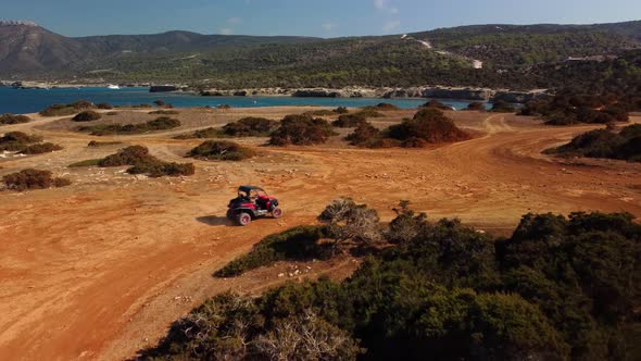 Aerial view of buggy car on the sandy on the sea coast of Cyprus or Greek in summer