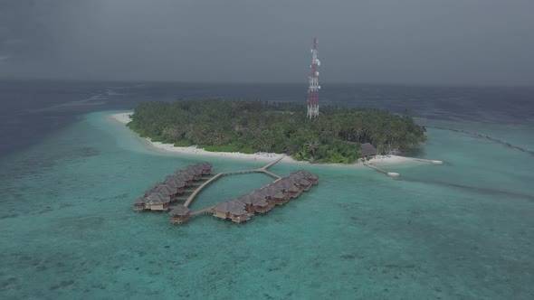 Aerial view of luxury bungalows on water, Island resort villas in Indian ocean, Maldives from drone alt