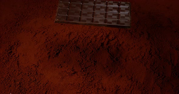 Chocolate Tablet falling on Black Chocolate Powder, Slow motion 4K alt