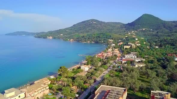 Corfu Island, Greece Aerial Shot. Drone Footage of Blue Water, Green Hills and Waterfront.