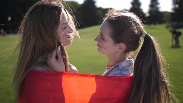 Happy Lesbians Enjoying Closeness Wrapped in Flag alt