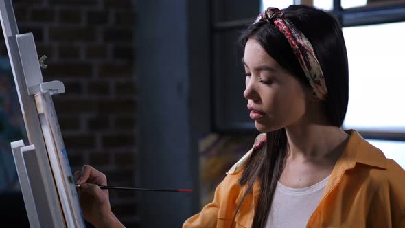 Talented Female Painter Intently Drawing Picture alt