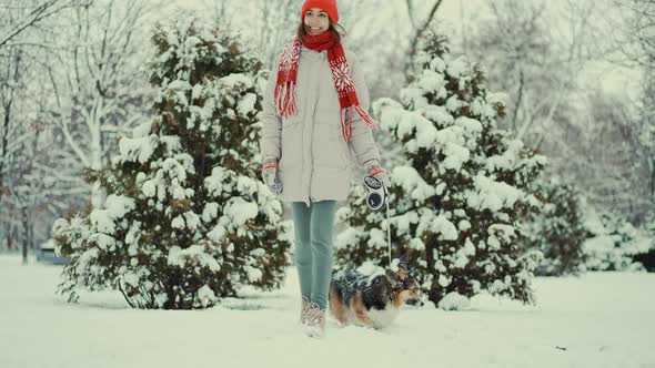 Slow Motion Portrait Beautiful Smiling Young Woman in Parka Knitted Red Beanie and Mittens Walks alt
