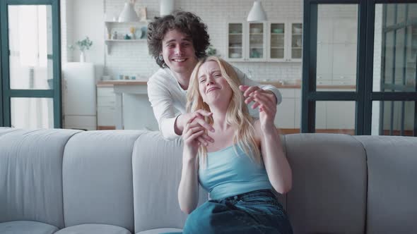 Guy Closing Girls's Eyes with Hands and Flirting Her Having Fun Feeling Love and Tenderness alt