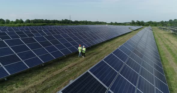 Aerial View of Engineering Checking Solar Cell Farm Electricity Production From the Sun alt