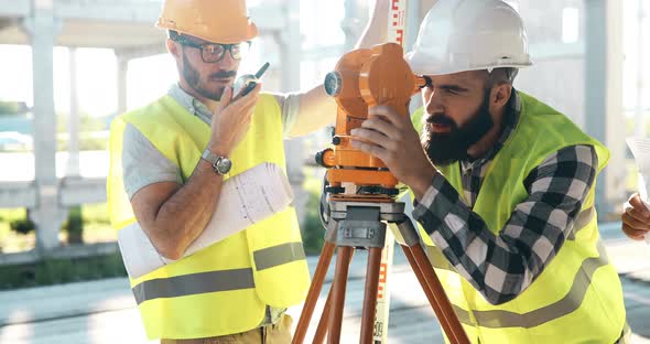 Portrait of Construction Engineers Working on Building Site alt