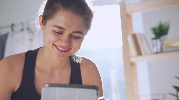Young Caucasian Lady Using Tablet in Slowmotion alt